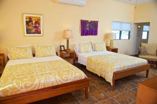 Katil atau katil-katil dalam bilik di Coral House Inn