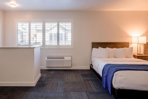 a hotel room with a bed and a window at Inn At Moss Landing Point in Moss Landing