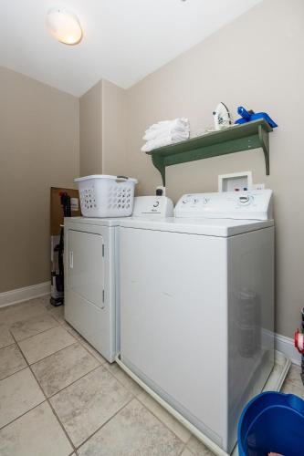a white washer and dryer in a room at Sunset Bay Villa 221 - Waterfront, Pool, Gym! in Chincoteague