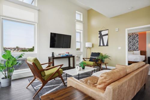 a living room with a couch and a tv at 2880 Skyline Penthouse at Espadin in Denver