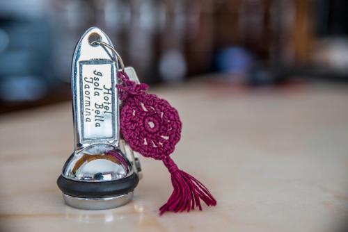 a bottle opener with a red yarn in it at Hotel Isola Bella in Taormina