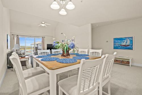 a dining room with a table and chairs at Sunset Bay Villa 312 - Waterfront & includes a boat slip! in Chincoteague