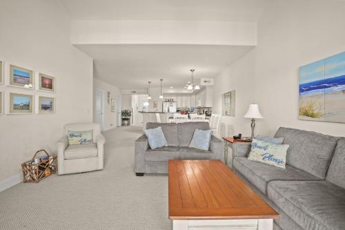 a living room with a couch and a table at Sunset Bay Villa 312 - Waterfront & includes a boat slip! in Chincoteague