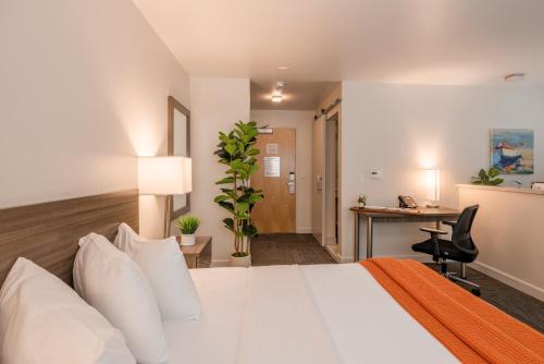 a hotel room with a bed and a desk at Inn At Moss Landing Point in Moss Landing