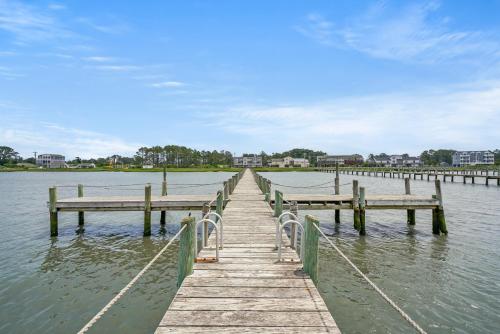 a wooden dock in the middle of a body of water at Sunset Dreams - Pet friendly, Waterfront, & shared dock! in Black Point Landing