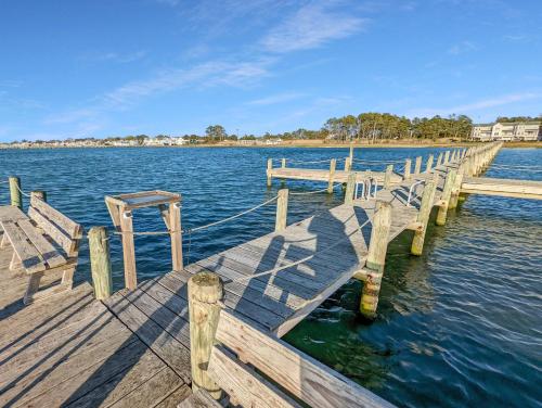 a wooden dock with benches on a body of water at Sunset Dreams - Pet friendly, Waterfront, & shared dock! in Black Point Landing