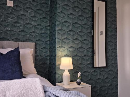 a bedroom with a bed and a mirror on a wall at 18 Anfield 5 min walk Sleeps 7 4BR 5Bed 3Bathrms in Liverpool