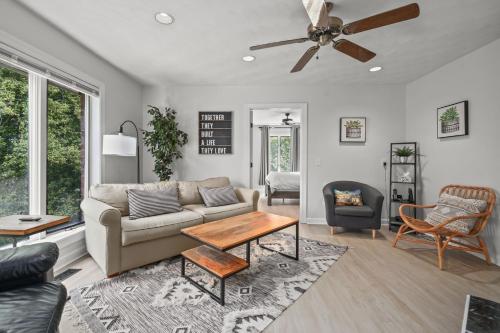 a living room with a couch and a table at Sunset on the Rocks - Luxurious beachfront comfort! in Cape Charles