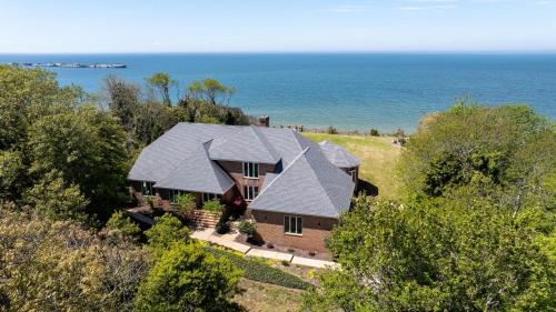 an aerial view of a house with the ocean in the background at Sunset on the Rocks - Luxurious beachfront comfort! in Cape Charles