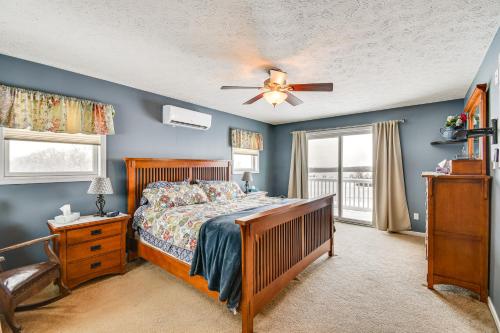 a bedroom with a bed and a ceiling fan at The Gathering Place Rushville Home with Hot Tub in Rushville