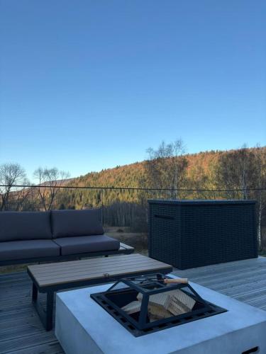 a patio with a couch and a table on a deck at Yama Krywe in Krywe