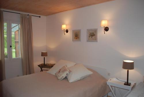 une chambre avec un lit avec deux lampes et une fenêtre dans l'établissement Provencal villa, Luberon Park, à Maubec