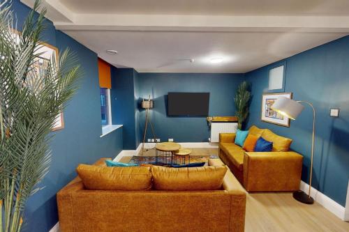 a living room with two couches and a tv at 3BR, song lyrics theme, self check-in in Manchester
