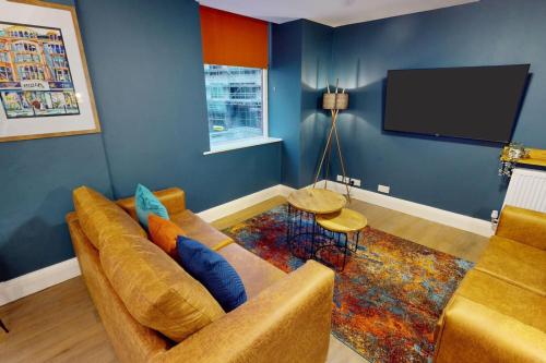 a living room with a couch and a flat screen tv at 3BR, song lyrics theme, self check-in in Manchester