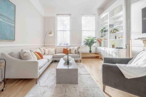a living room with two couches and a table at 2BR, garden, 60" TV with sound system in London
