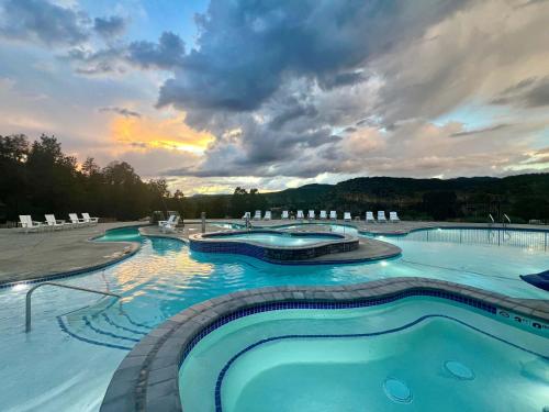 a large swimming pool with a sunset in the background at Yurt Overlook #5 with AC and Private Bath 2 Kings in Orderville