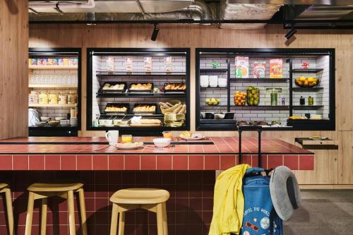 a fast food restaurant with a counter and stools at Moxy Annecy in Annecy