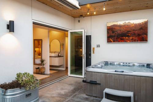 a large bathroom with a jacuzzi tub at Ventana Cove Pickleball Retreat in Yucca Valley
