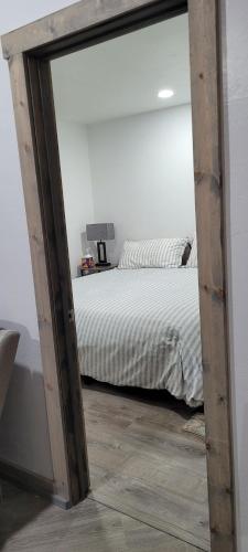 a bedroom with a bed and a large mirror at Greer Point Trails End Cabins in Greer