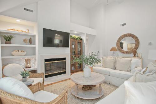 a living room with white furniture and a fireplace at 2908 Captain Sams in Seabrook Island