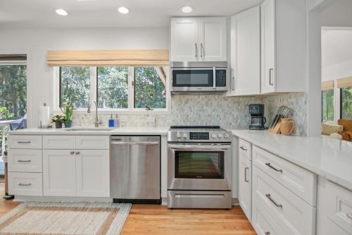 a kitchen with white cabinets and stainless steel appliances at 2908 Captain Sams in Seabrook Island