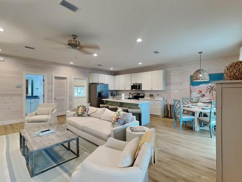 een woonkamer met witte meubels en een keuken bij Cottages at Old Bay #5 in Orange Beach