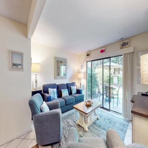 a living room with a couch and a table at Walk to the Beach and Coligny! in Hilton Head Island