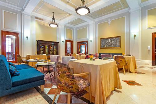 a large room with a table and chairs and a room with tables at Taj Cape Town - Spacious 5 star luxury residence with kitchenette in Cape Town