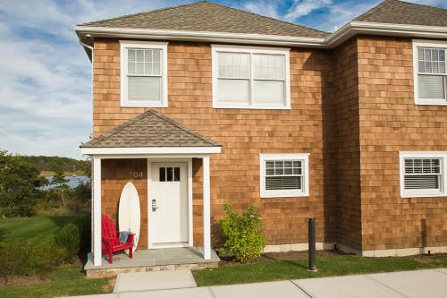 a house with a red chair on the doorstep at North Harbor Montauk in Montauk
