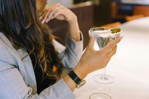 a woman holding a wine glass with a piece of food in it at Marriott Quebec City Downtown in Quebec City