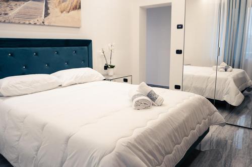 a bedroom with a bed with two towels on it at House 21 Residence Room in Collecchio