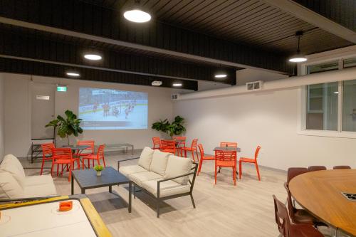 a meeting room with chairs and tables and a projection screen at Scott's Inn & Suites in Kamloops