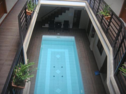 an overhead view of a swimming pool in a building at Hidden Pearl Hotel (Janus Luxury Suites) in Angeles