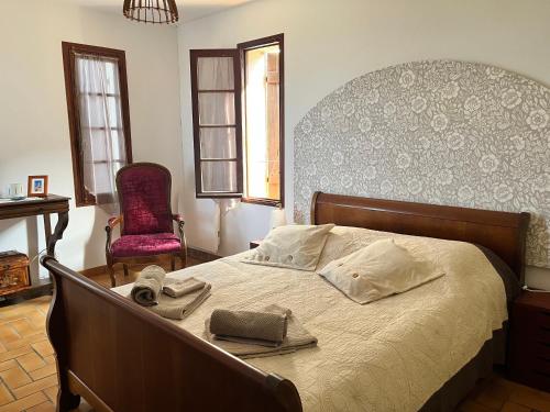 a bedroom with a bed with two towels on it at Campuleccia in Lumio