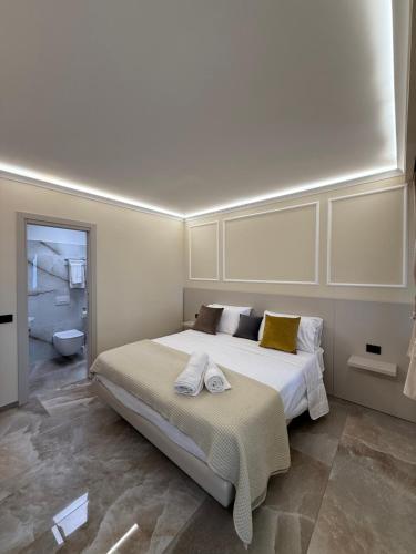 a bedroom with a large bed and a bathroom at Bonocore Accomodation in Tropea