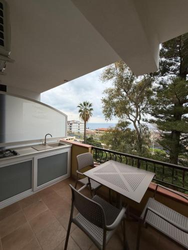 a kitchen with a table and chairs on a balcony at Bonocore Accomodation in Tropea