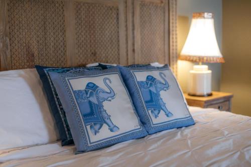 two blue and white pillows on top of a bed at Bann at Oak Knoll Napa in Napa