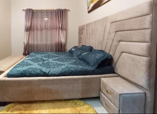 a bedroom with a bed with a head board at Doreens Villa in Wakiso