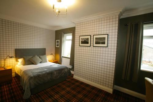 a bedroom with a bed in the corner of a room at The Sunningdale in Bamburgh