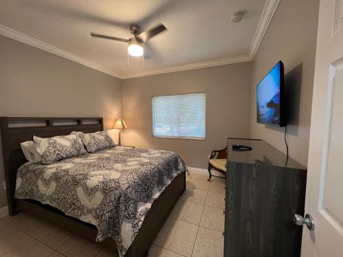 a bedroom with a bed and a flat screen tv at Homestead Green retreat in Homestead