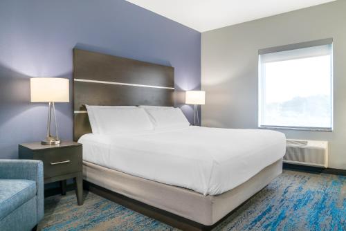 a bedroom with a large white bed and a window at Comfort Inn & Suites Adrian in Adrian