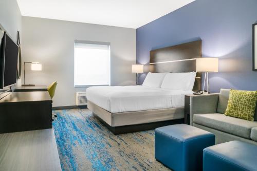 a hotel room with a bed and a couch at Comfort Inn & Suites Adrian in Adrian