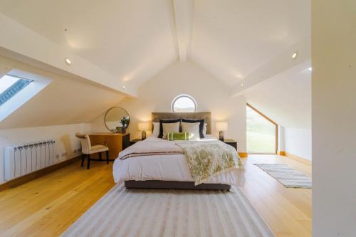 a bedroom with a large bed and a window at Cobstone Cottage in Walmersley