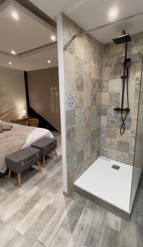- une chambre principale avec un lit et une douche dans l'établissement Gîte Les Eaux du Moulin piscine chauffée et jacuzzi, à Vittefleur