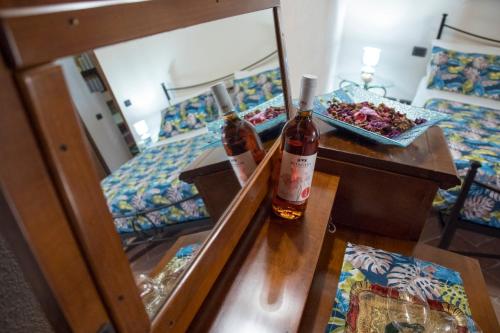 a hotel room with two beds and two bottles of alcohol at Podere Cerciano in Radicondoli