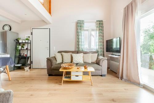 a living room with a couch and a table at Meliterra in Gialova