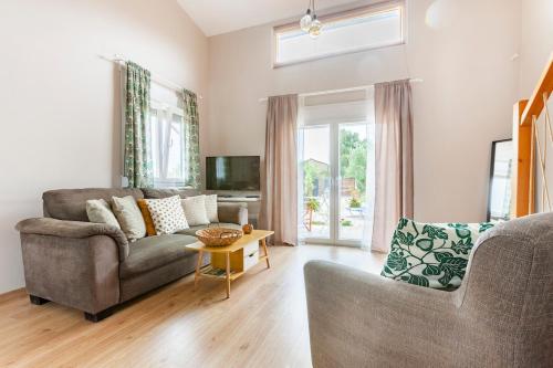 a living room with a couch and a table at Meliterra in Gialova