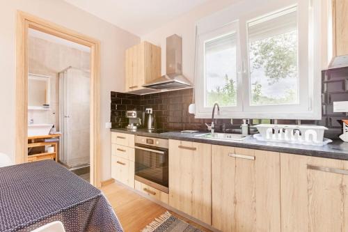 a kitchen with wooden cabinets and a sink and a window at Meliterra in Gialova