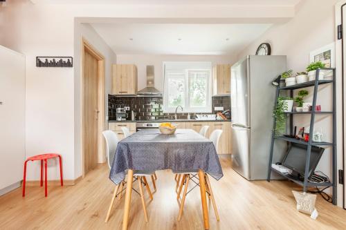 a kitchen with a table with chairs and a refrigerator at Meliterra in Gialova