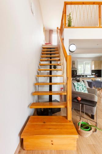a wooden staircase in a living room with a couch at Meliterra in Gialova